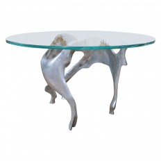 Circular glass dining table with abstract base
